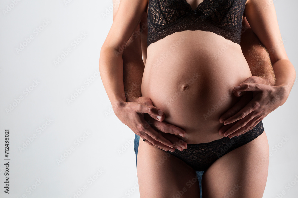 Young man and pregnant woman in studio Young man and pregnant woman in studio