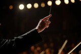 A man in a suit holding a conductor's baton. Suitable for music-related projects and events