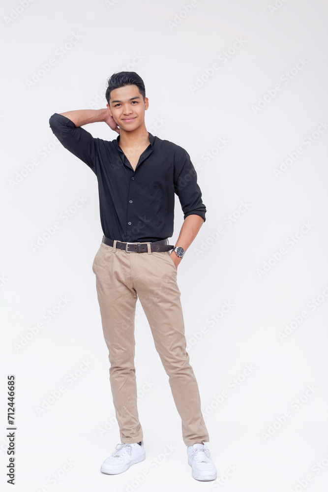 Handsome and fashionable Filipino man with swagger, wearing black polo shirt and khaki pants. Full body photo, isolated on a white background. Handsome and fashionable Filipino man with swagger, wearing black polo shirt and khaki pants. Full body photo, isolated on a white background.