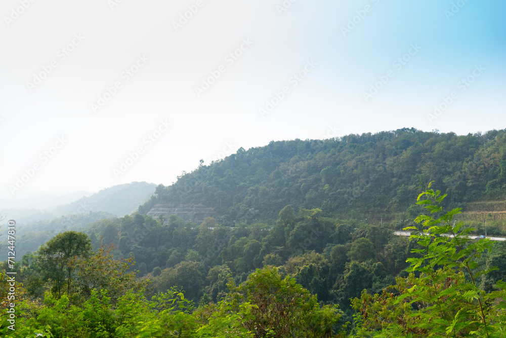 Landscape view of mountain at Khao Plung Rest Stop Uttaradit Thailand. Road cuts through the mountains. Under light of blue sky. Landscape view of mountain at Khao Plung Rest Stop Uttaradit Thailand. Road cuts through the mountains. Under light of blue sky.