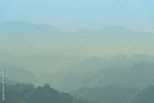 Abstract nature background of complex mountains. Lined up in the distance and disappeared into the mist.