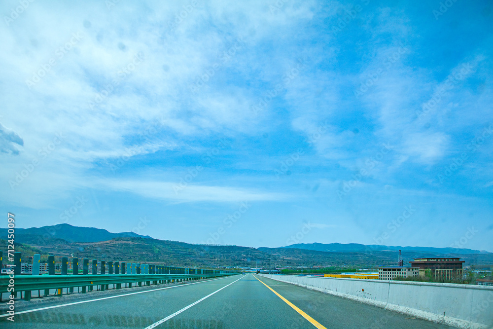 Pingliang City, Gansu Province - Road and field scenery under the blue sky Pingliang City, Gansu Province - Road and field scenery under the blue sky