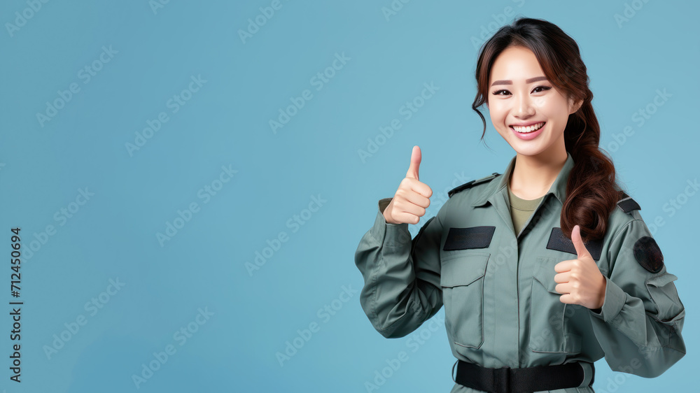 Asian woman in air force uniform smiling isolated on pastel background Asian woman in air force uniform smiling isolated on pastel background