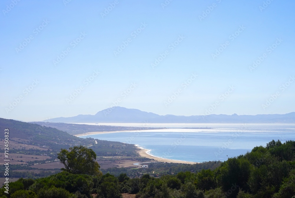 view from a mountain along the coastline of the Costa de la Luz, Andalusia, Spain with the mountains of Morocco behind the Strait of Gibraltar at the horizon