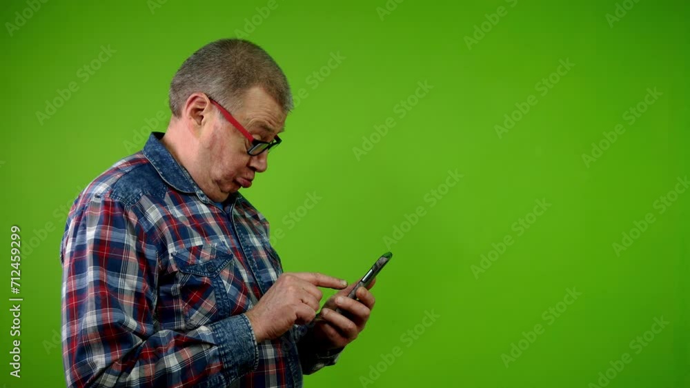 Senior man reads message in smartphone and can not understand anything. Senior man reads message in smartphone and can not understand anything.