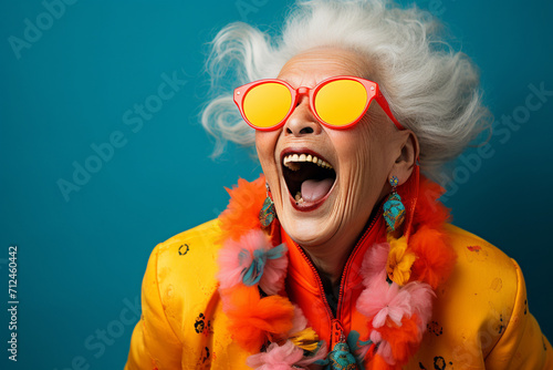 A candid moment frozen in time, capturing the genuine laughter and amusement of a person against a bold and vibrant plain background. photo