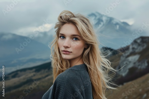 beautiful blonde woman on mountain landscape © Muh