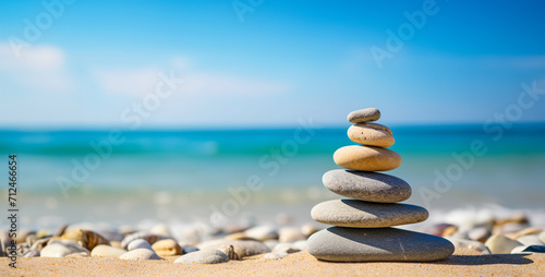 Pyramid of pebbles on the seashore.Stacked stones on the beach at sunset. Beautiful seascape