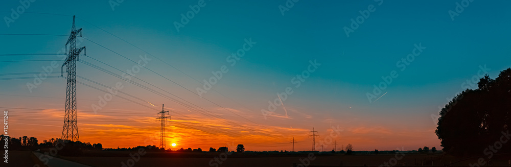 High resolution stitched alpine summer sunset panorama with overland high voltage lines near Aholming, Deggendorf, Bavaria, Germany