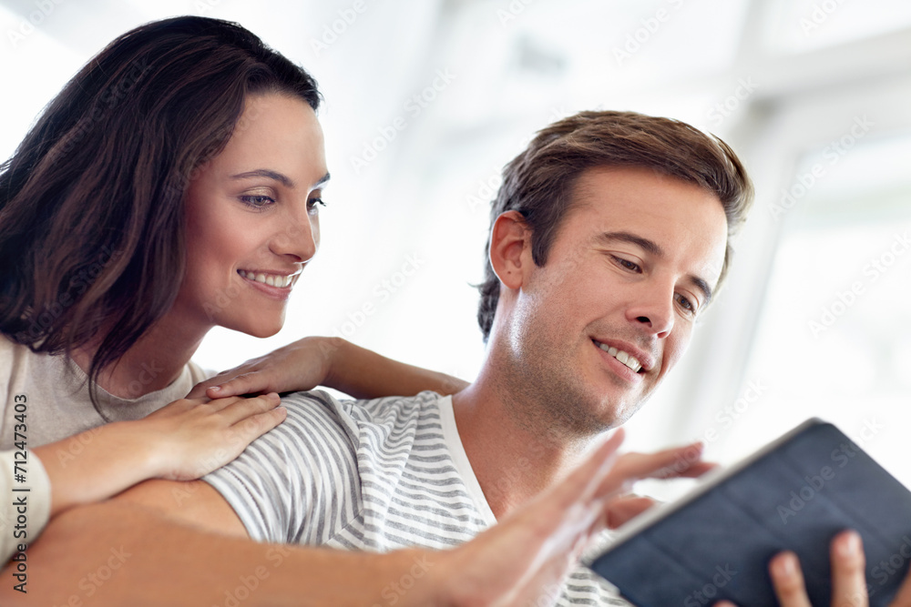 Tablet, search and happy couple in a house with social media, streaming or watching video, film or show at home. Digital, app or people with love online in living room for web communication or scroll Tablet, search and happy couple in a house with social media, streaming or watching video, film or show at home. Digital, app or people with love online in living room for web communication or scroll
