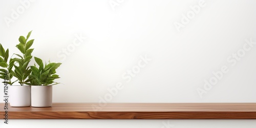 Wooden tabletop on a white wall with leafy backdrop; ideal for showcasing products or designing visuals.