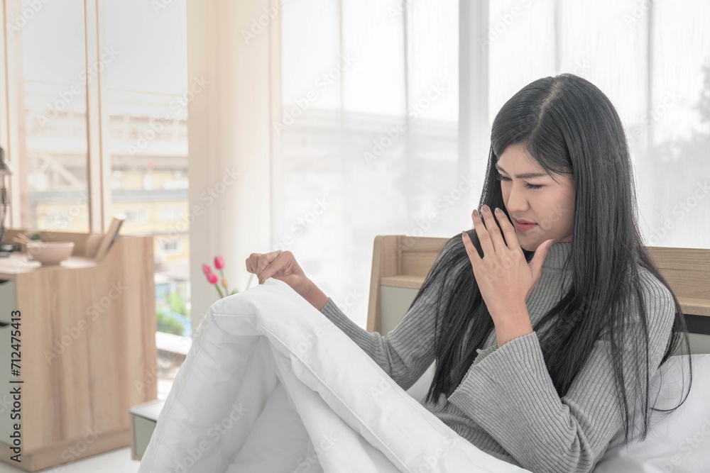 Fotka „Beautiful woman stinky blanket and pillow breath fingers on nose