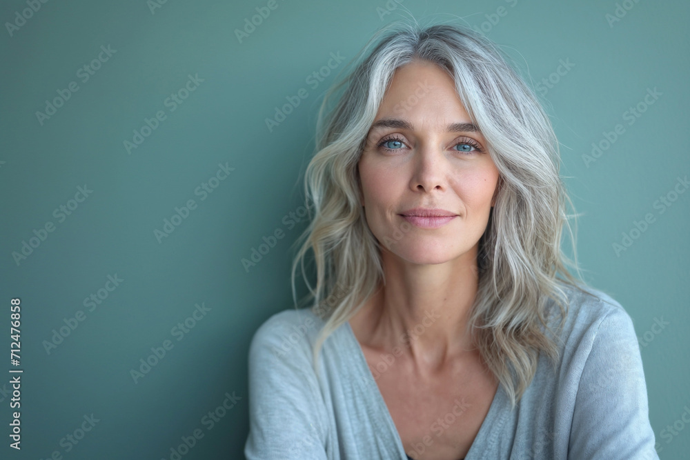 Smiling attractive woman 40s years old look to the camera, isolated on blue background with copy space. Smiling attractive woman 40s years old look to the camera, isolated on blue background with copy space.