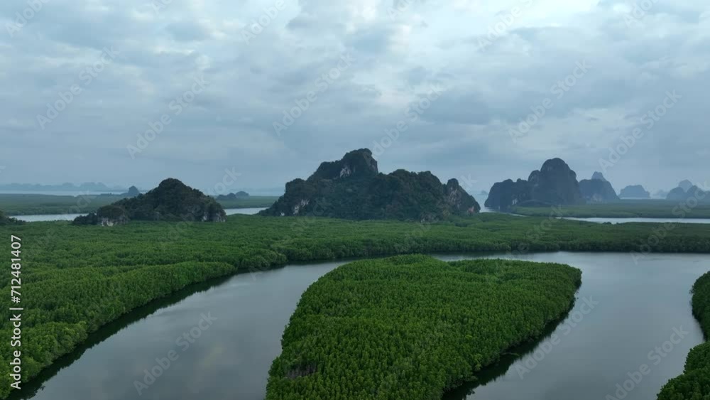 View from above, stunning aerial view of Ao Phang Nga (Phang Nga Bay) National Park featuring a multitude of limestone formations rising majestically from the sea near the coast. Thailand View from above, stunning aerial view of Ao Phang Nga (Phang Nga Bay) National Park featuring a multitude of limestone formations rising majestically from the sea near the coast. Thailand