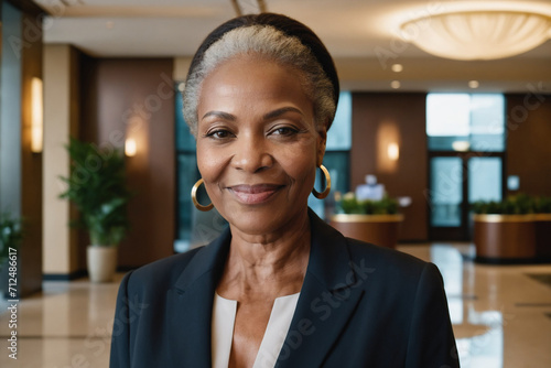 portrait of old age black businesswoman in modern hotel lobby