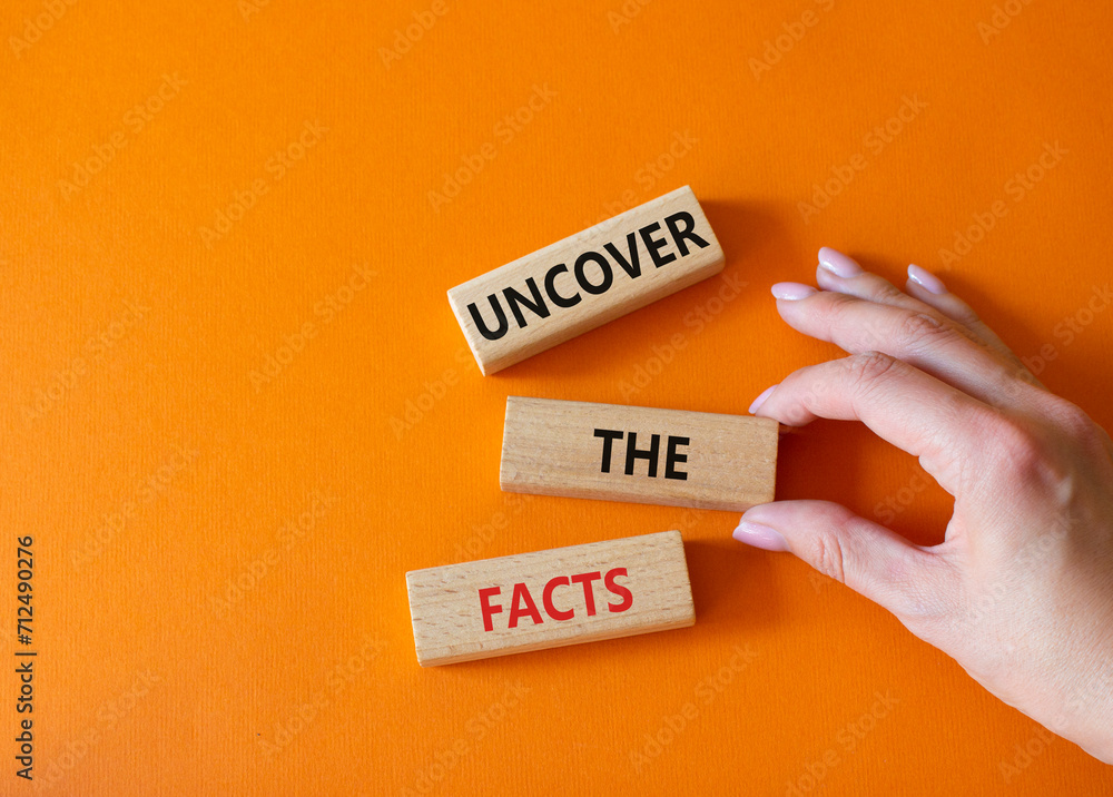 Uncover the Facts symbol. Concept word Uncover the Facts on wooden Uncover the Facts symbol. Concept word Uncover the Facts on wooden