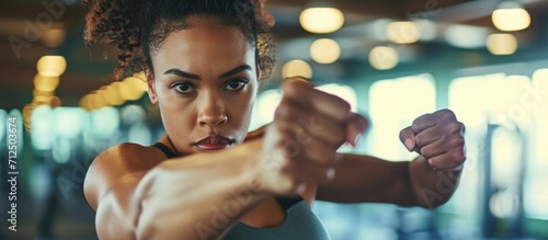 Woman practicing punches at health club. photo