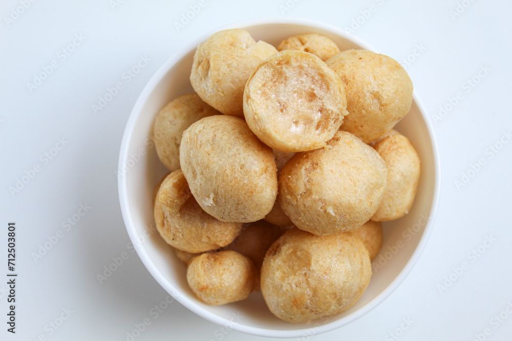 Bitten fish crackers in ball shape. isolated on white background, flat lay or top view Bitten fish crackers in ball shape. isolated on white background, flat lay or top view