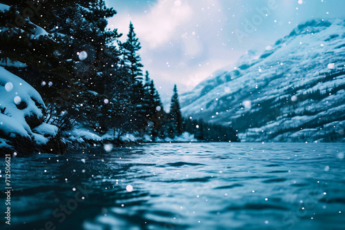 Snowy winter landscape with frozen lake and snowflakes in mountains