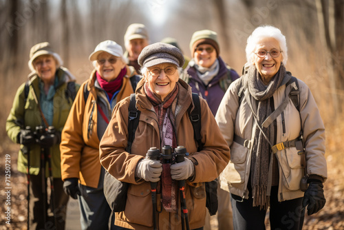 A spirited group of seniors engaged in a bird-watching excursion, appreciating the beauty of nature and fostering a sense of environmental awareness. photo