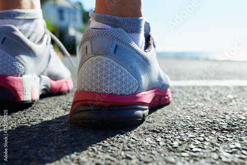 Fototapeta Naklejka Na Ścianę i Meble -  Feet, rear view and runner on street for fitness, health or cardio training in preparation or marathon. Sports, exercise and running shoes with person on asphalt for workout, performance or race