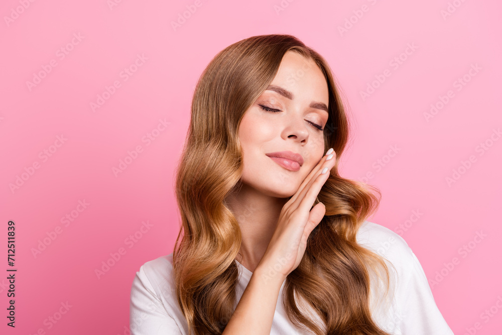 Photo of charming young relaxed lady closed eyes hand touch cheek perfection skin applying cream lotion isolated on pink color background Photo of charming young relaxed lady closed eyes hand touch cheek perfection skin applying cream lotion isolated on pink color background