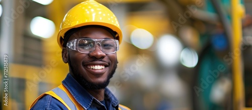 Grinning African American industrial specialist in metal construction. © AkuAku