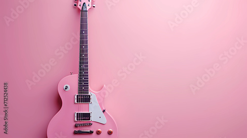Pink electric guitar, electronic soft pink guitar on a light pink background