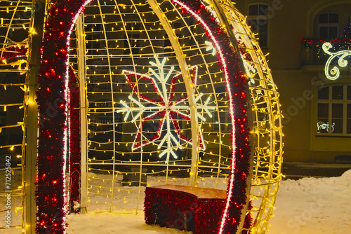 A snowflake on a glowing bauble - Christmas illumination on the market square in Lubliniec. Christmas 2023. photo