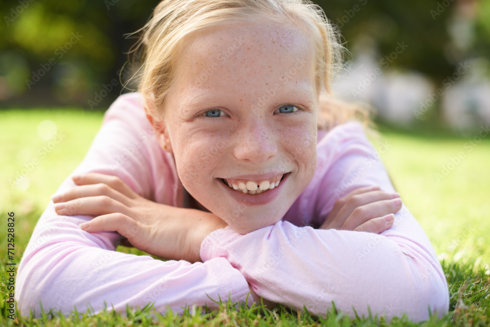Happy, portrait and girl child lying in grass for fun, play and adventure in nature. Face, smile and kid in garden with positive attitude, mindset and excited for exploring, learning or weekend break Happy, portrait and girl child lying in grass for fun, play and adventure in nature. Face, smile and kid in garden with positive attitude, mindset and excited for exploring, learning or weekend break
