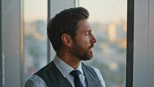 Portrait man professional contemplating business deal stand at panoramic window