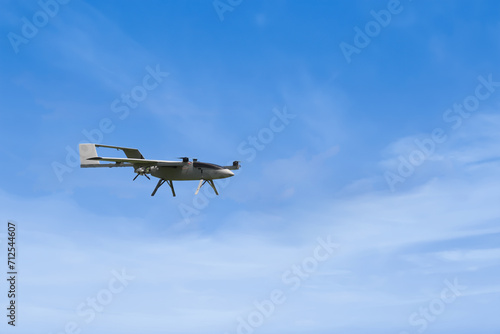 DIY Unmanned Aerial Vehicle made by college student, flying through the air against the sun