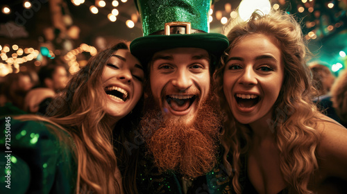 A guy and two girls laughing in St Patrick's hats, a fun party on a lucky day