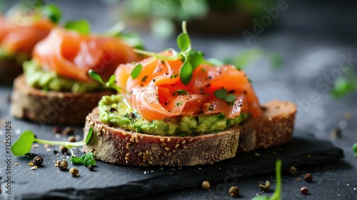 Open sandwiches with salted salmon, guacamole avocado and microgreens. Healthy food