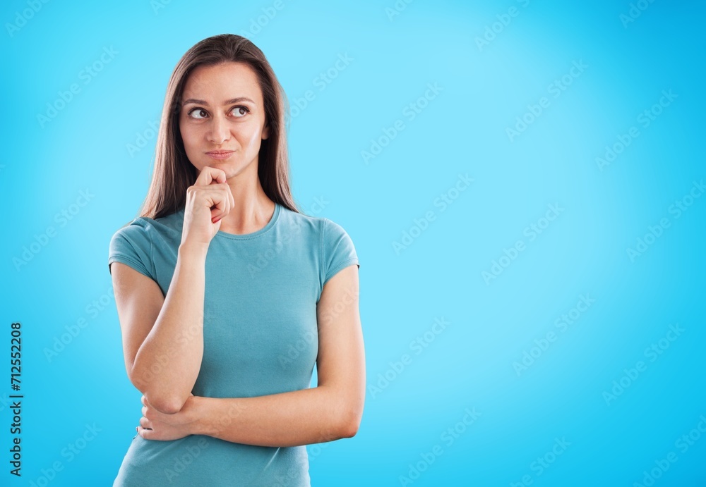 Lovely girl thinking looking upwards on background. Lovely girl thinking looking upwards on background.