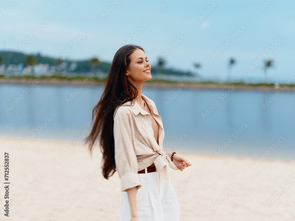 Joyful Summer Getaway: Beautiful Young Woman Walking Alone on a White Sandy Beach, Enjoying the Warmth of the Sun and Cool Breeze of the Azure Ocean Joyful Summer Getaway: Beautiful Young Woman Walking Alone on a White Sandy Beach, Enjoying the Warmth of the Sun and Cool Breeze of the Azure Ocean