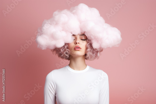 a young woman with her head in pink cloud on a pastel pink background