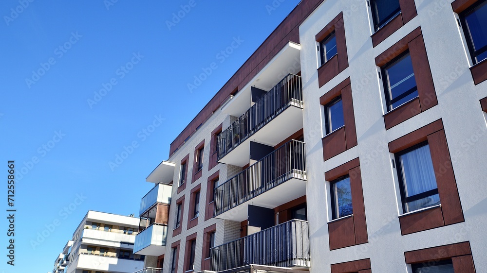 Obraz premium Modern apartment building in sunny day. Exterior, residential house facade. Residential area with modern, new and stylish living block of flats.