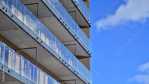 Modern apartment building in sunny day. Exterior, residential house facade. Residential area with modern, new and stylish living block of flats. 