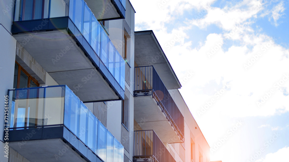 Fototapeta premium Modern apartment building in sunny day. Exterior, residential house facade. Residential area with modern, new and stylish living block of flats. 