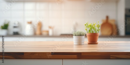 Empty table in front of a blurred modern kitchen room - ideal for product display or montage.