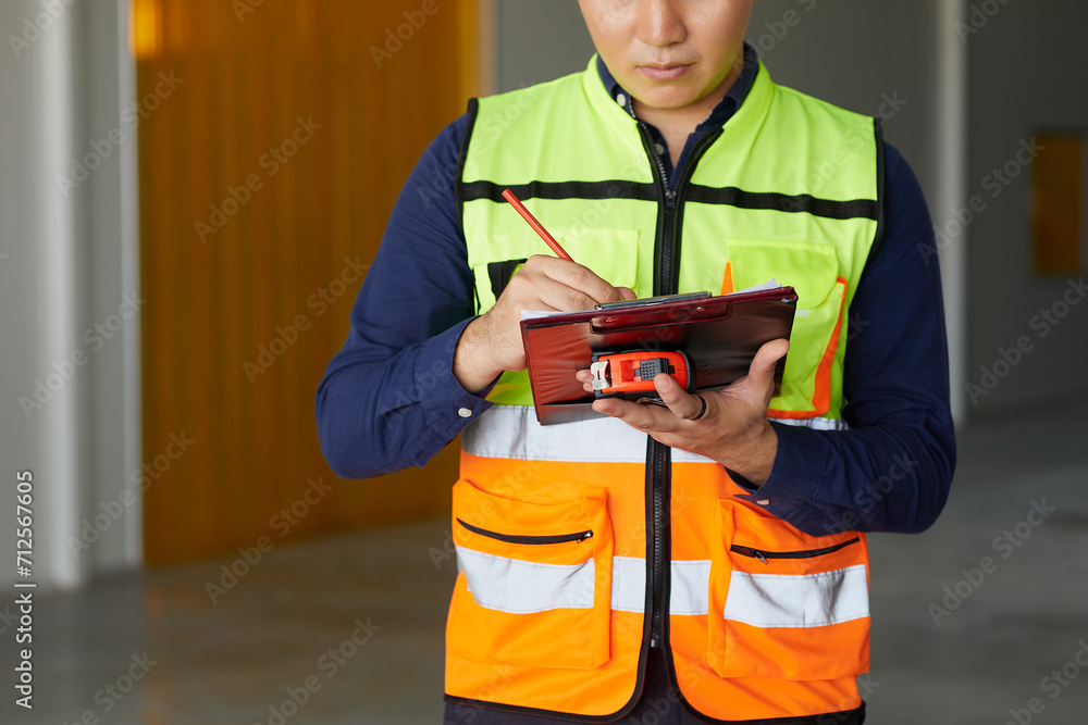 closeup worker hands writing on clipboard in the factory closeup worker hands writing on clipboard in the factory