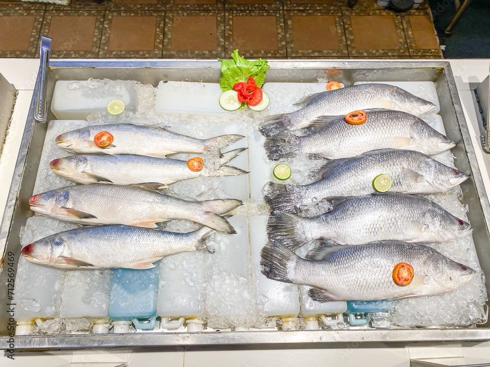 Fresh frozen barramundi and fourfinger threadfin fish with ice sold at