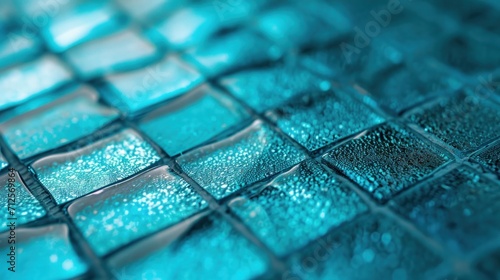  a close up shot of a blue glass mosaic tile pattern that looks like it has drops of water on it. photo