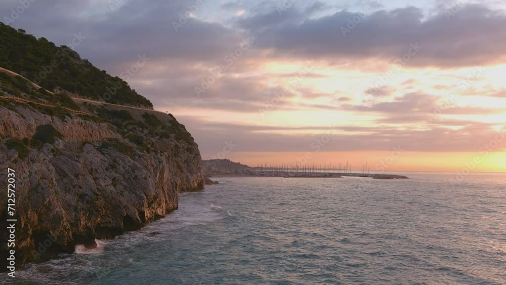 Water crashing against cliff in Costa del Garraf. Puerto Ginesta in distance, Barcelona Water crashing against cliff in Costa del Garraf. Puerto Ginesta in distance, Barcelona
