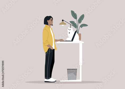 A young freelancer diligently working from home, their desk thoughtfully adjusted to a standing position, a setup believed to be beneficial for spinal health