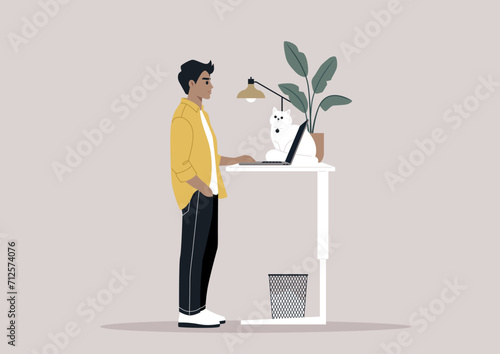 A young freelancer diligently working from home, their desk thoughtfully adjusted to a standing position, a setup believed to be beneficial for spinal health