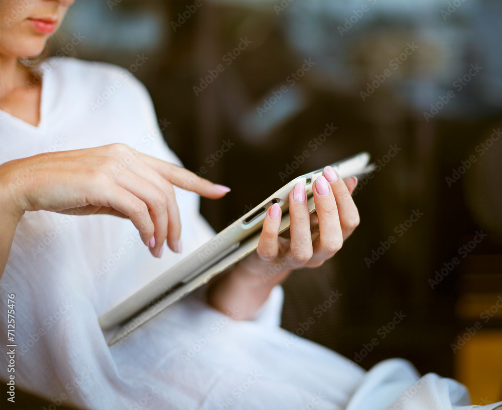 Young woman having fun using a tablet computer outdoors