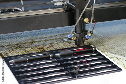 Laser engraving machine printing on pens photo