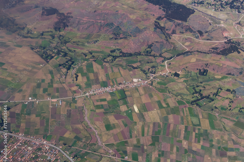 Aerial Shot Of Agricultural Fields And Small Village Along Road Aerial Shot Of Agricultural Fields And Small Village Along Road